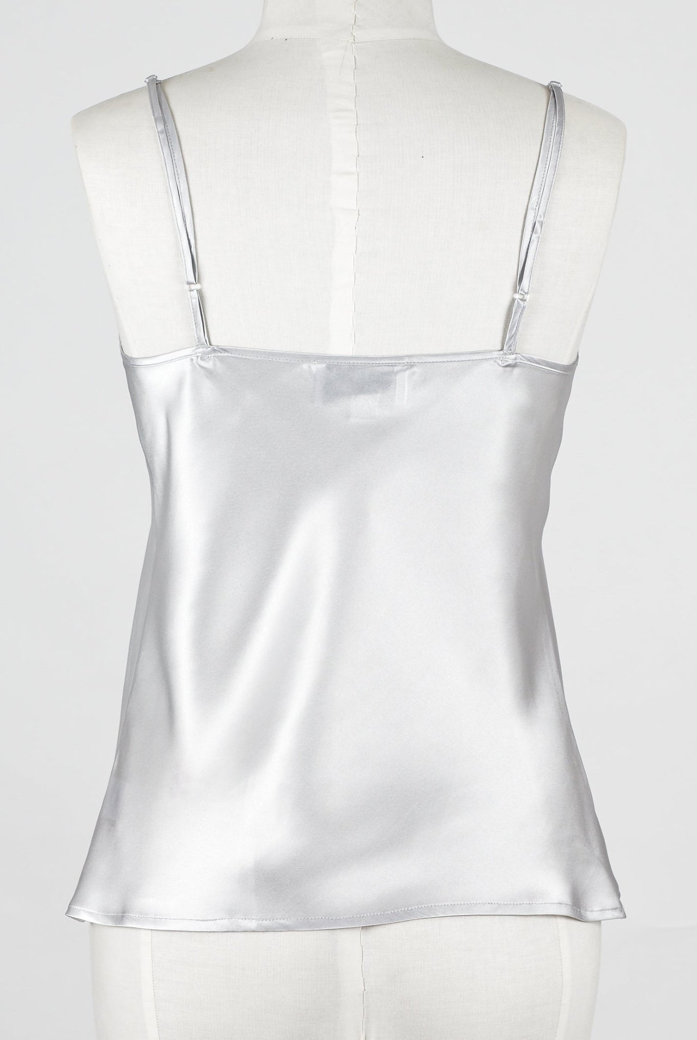 a silver gray silk camisole top with embroidered lace detailing.