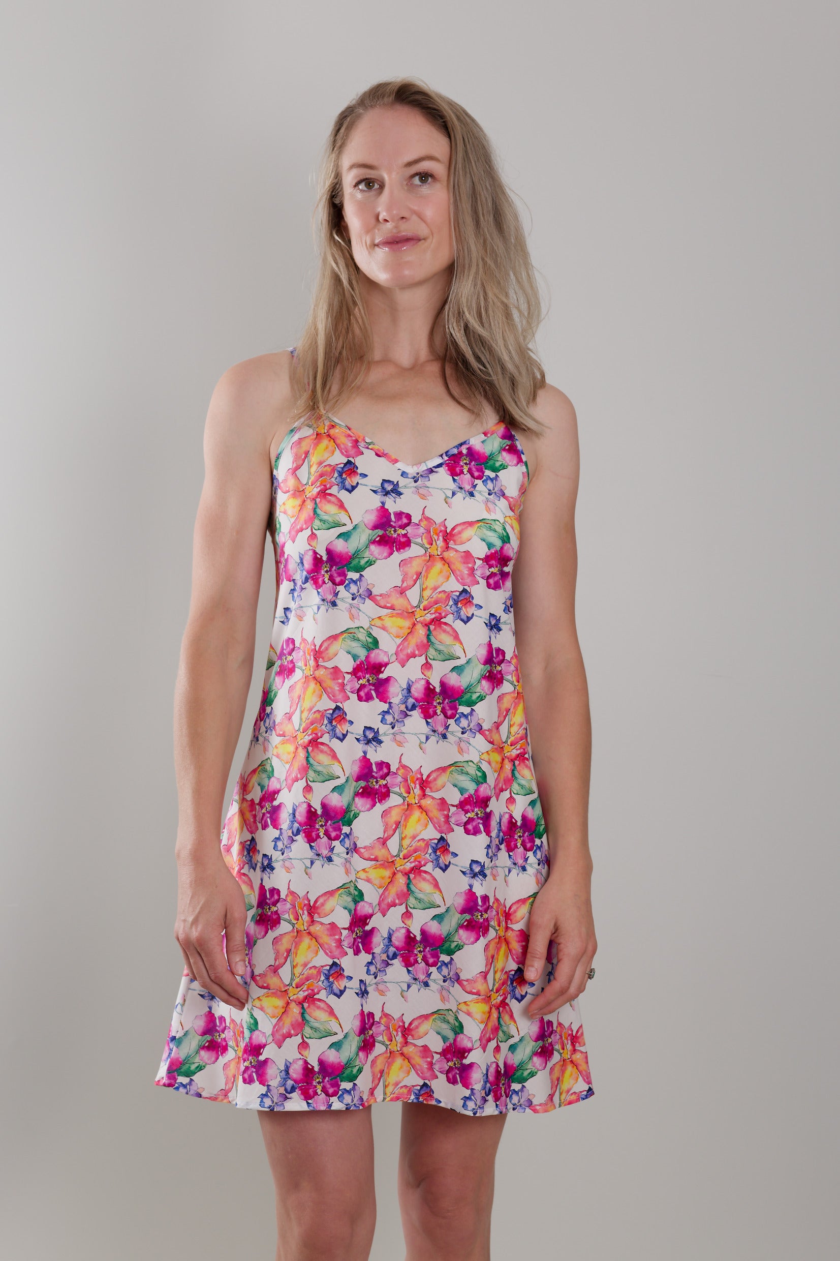 women wearing cotton slip dress nightie with bright floral print in orange and pink flowers