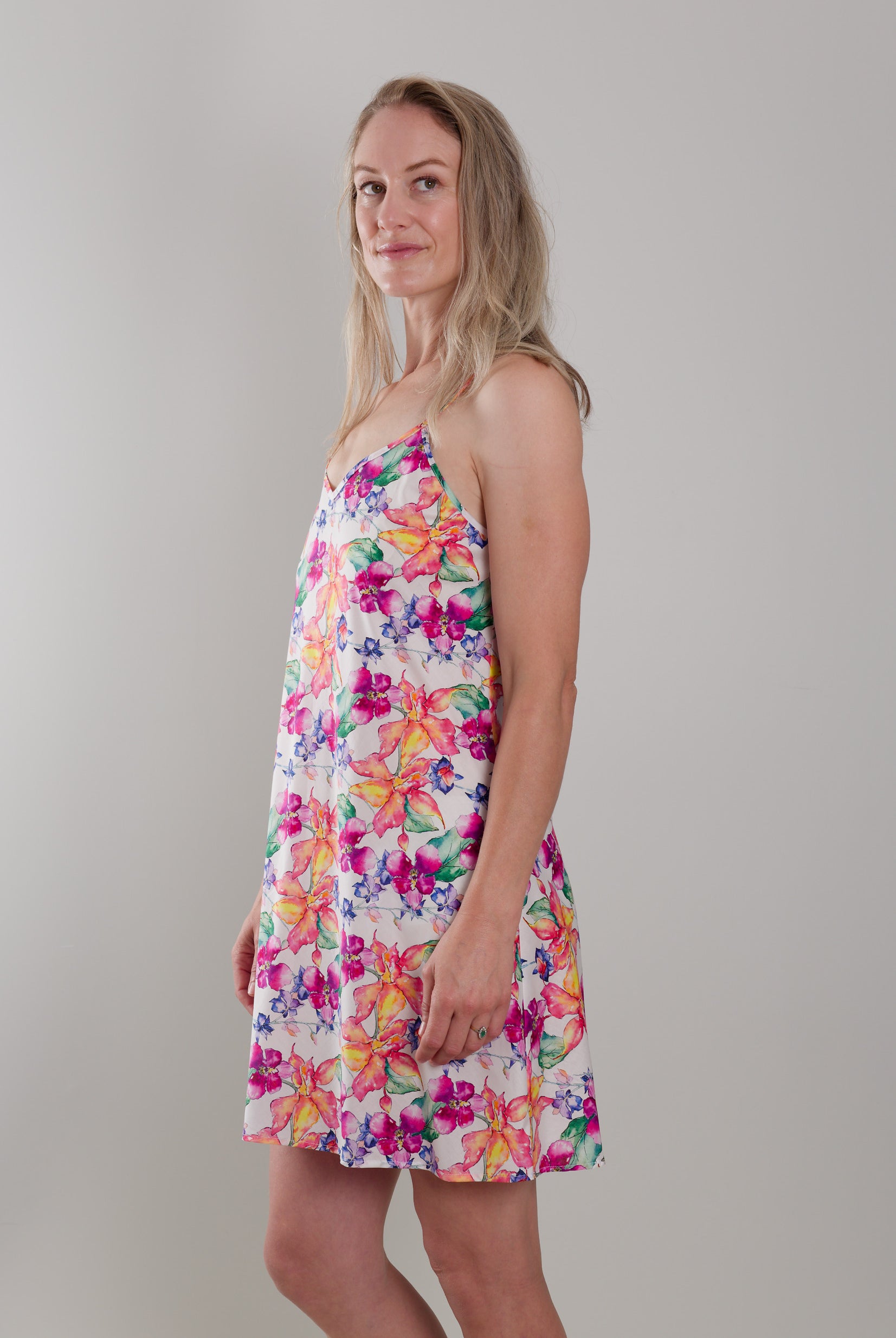 women wearing cotton slip dress nightie with bright floral print in orange and pink flowers