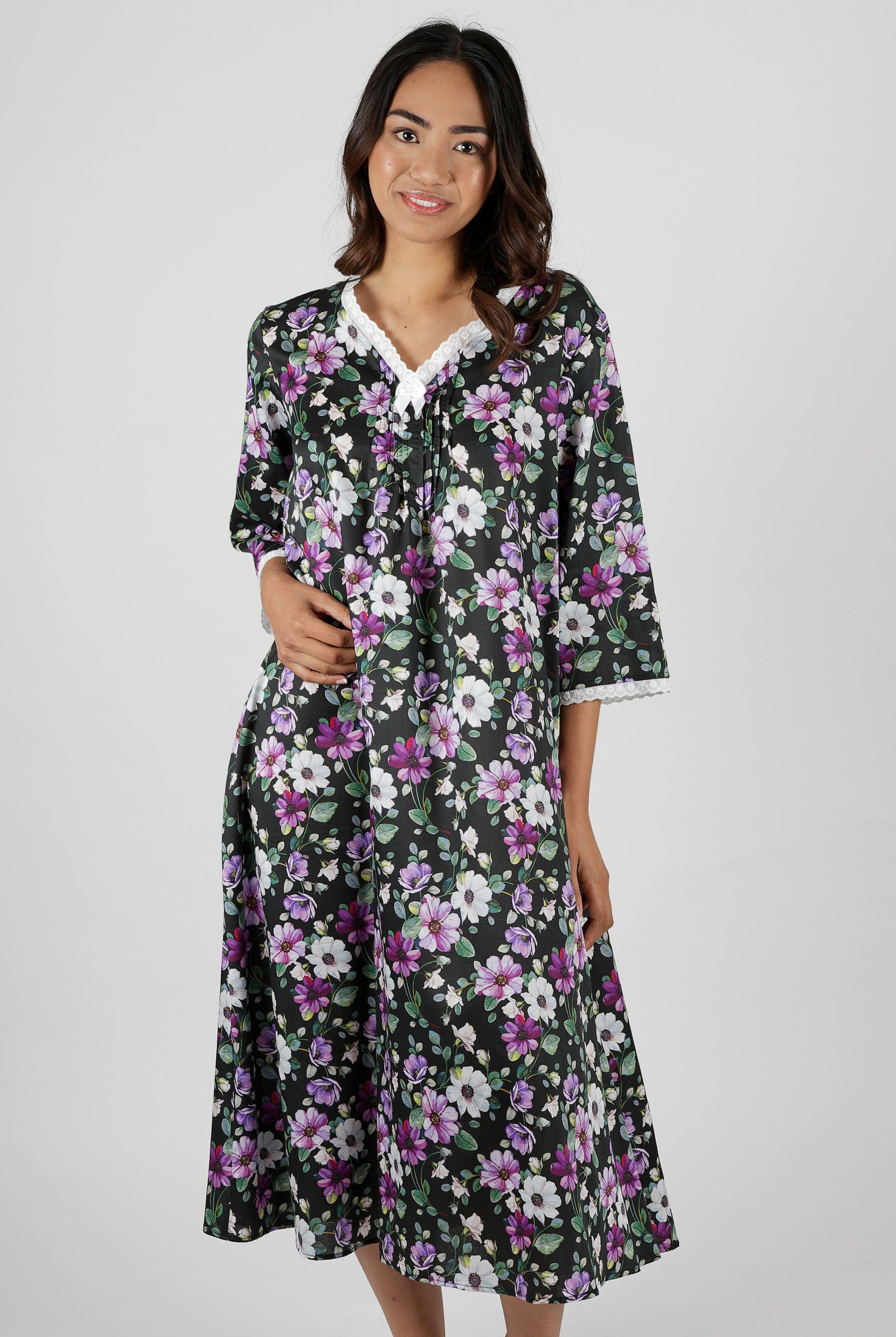 Woman wearing a floral nightie dress with white and purple flowers