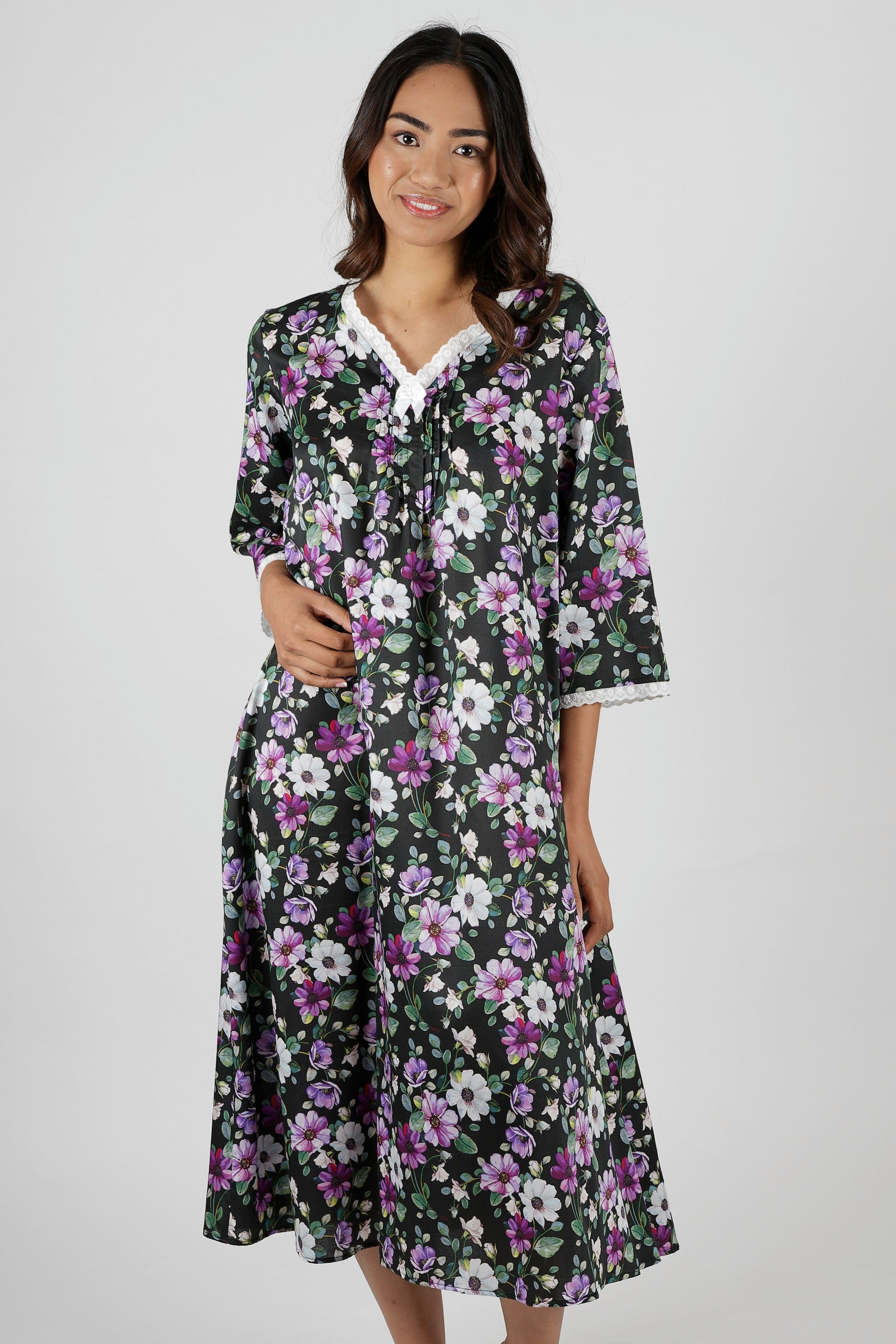 Woman wearing a floral nightie dress with white and purple flowers