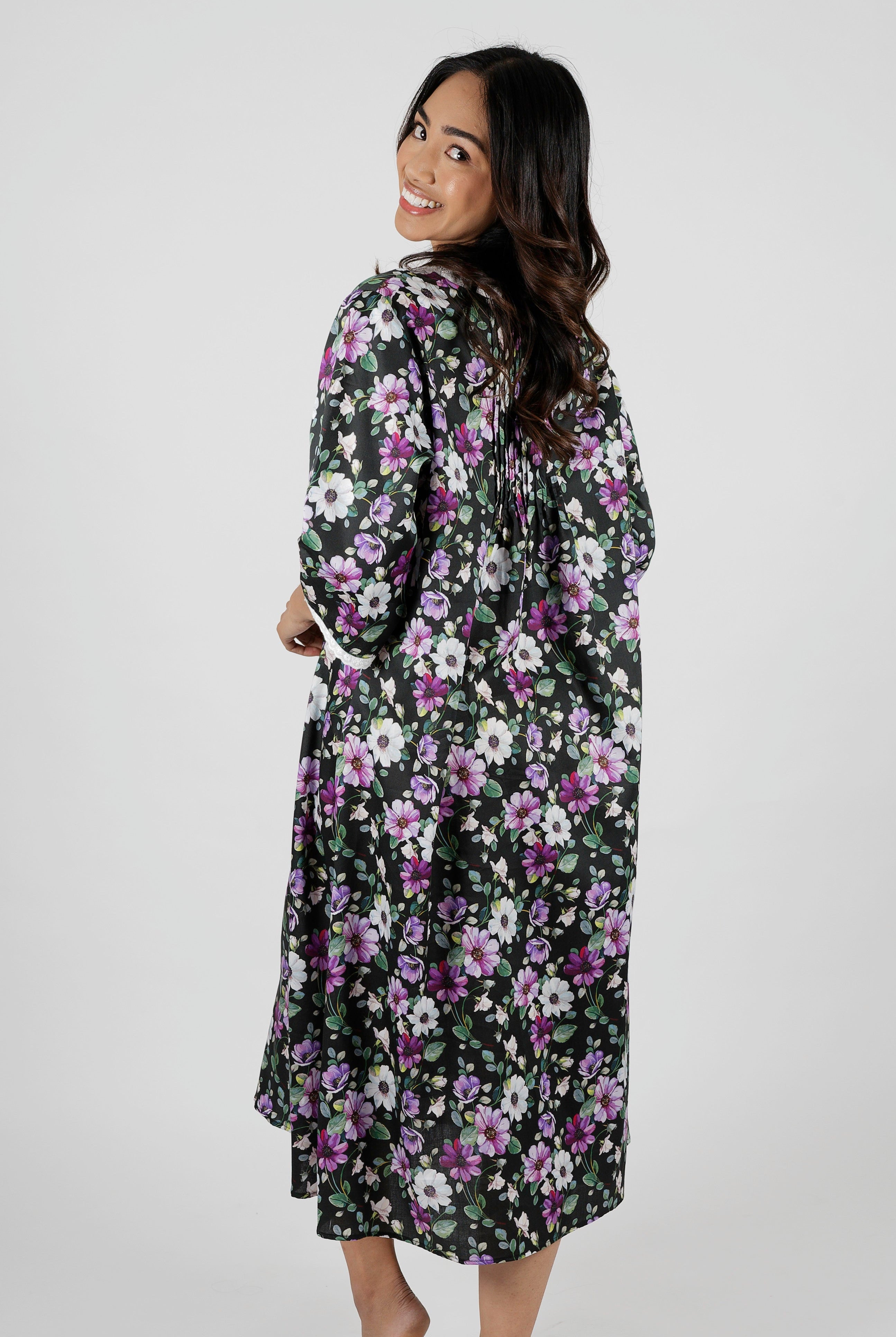 Woman wearing a floral nightie dress with white and purple flowers