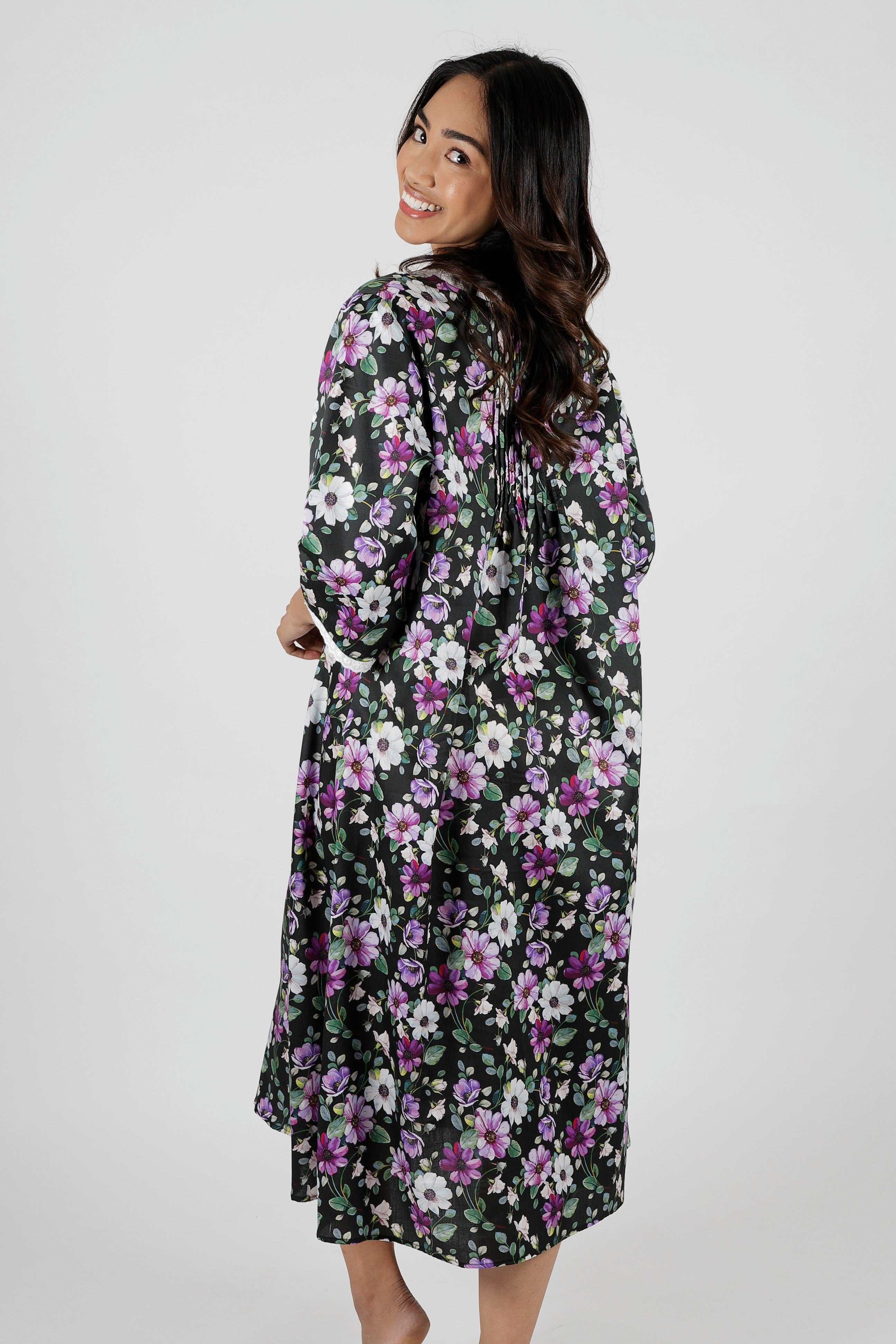 Woman wearing a floral nightie dress with white and purple flowers
