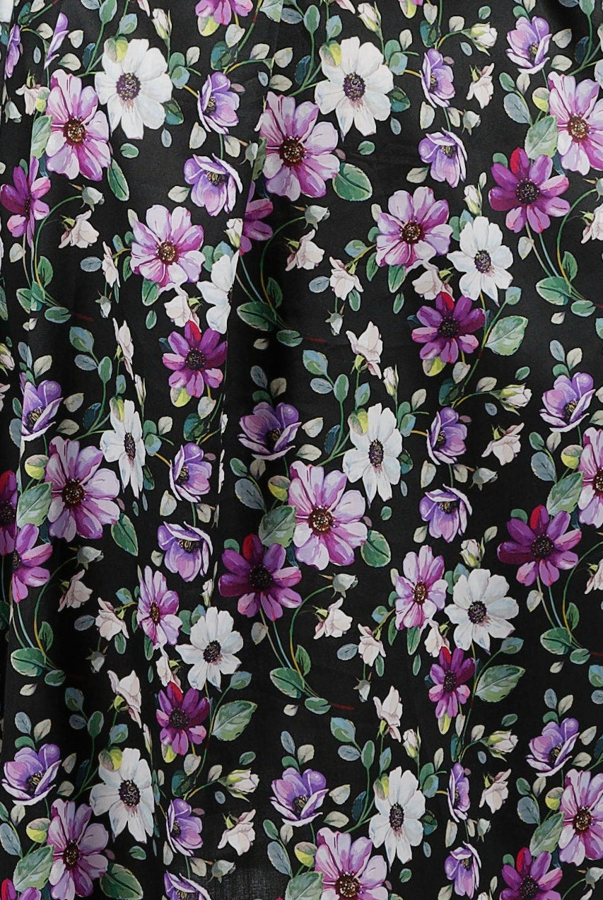 Woman wearing a floral nightie dress with white and purple flowers
