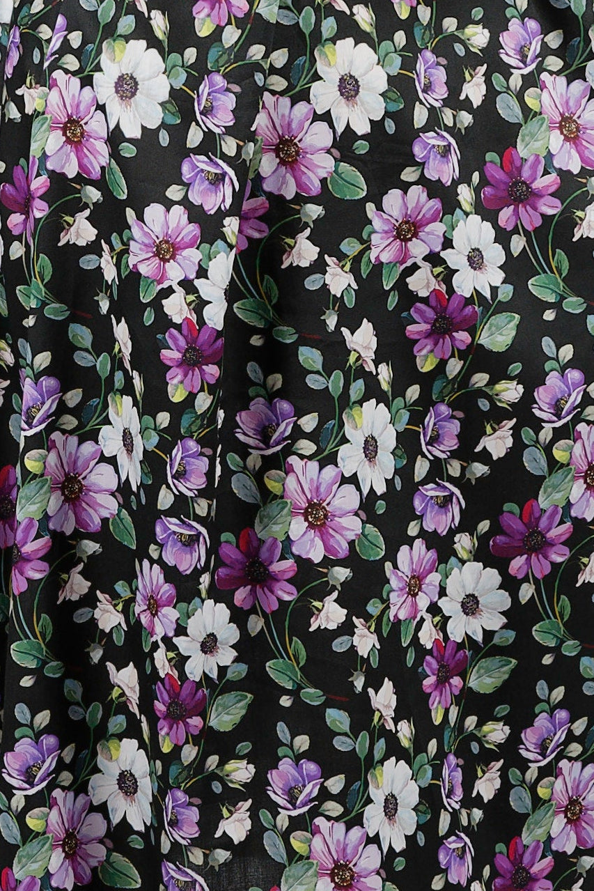 Woman wearing a floral nightie dress with white and purple flowers