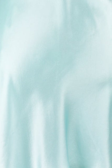 A light mint green satin silk slip dress displayed on a white mannequin torso against a light gray background.