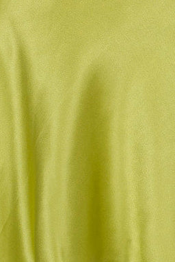 Green satin silk slip dress on a mannequin against a white background
