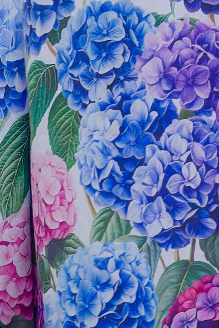 close up of floral cotton nightie with hydrangea flowers on it in blue purple and pink
