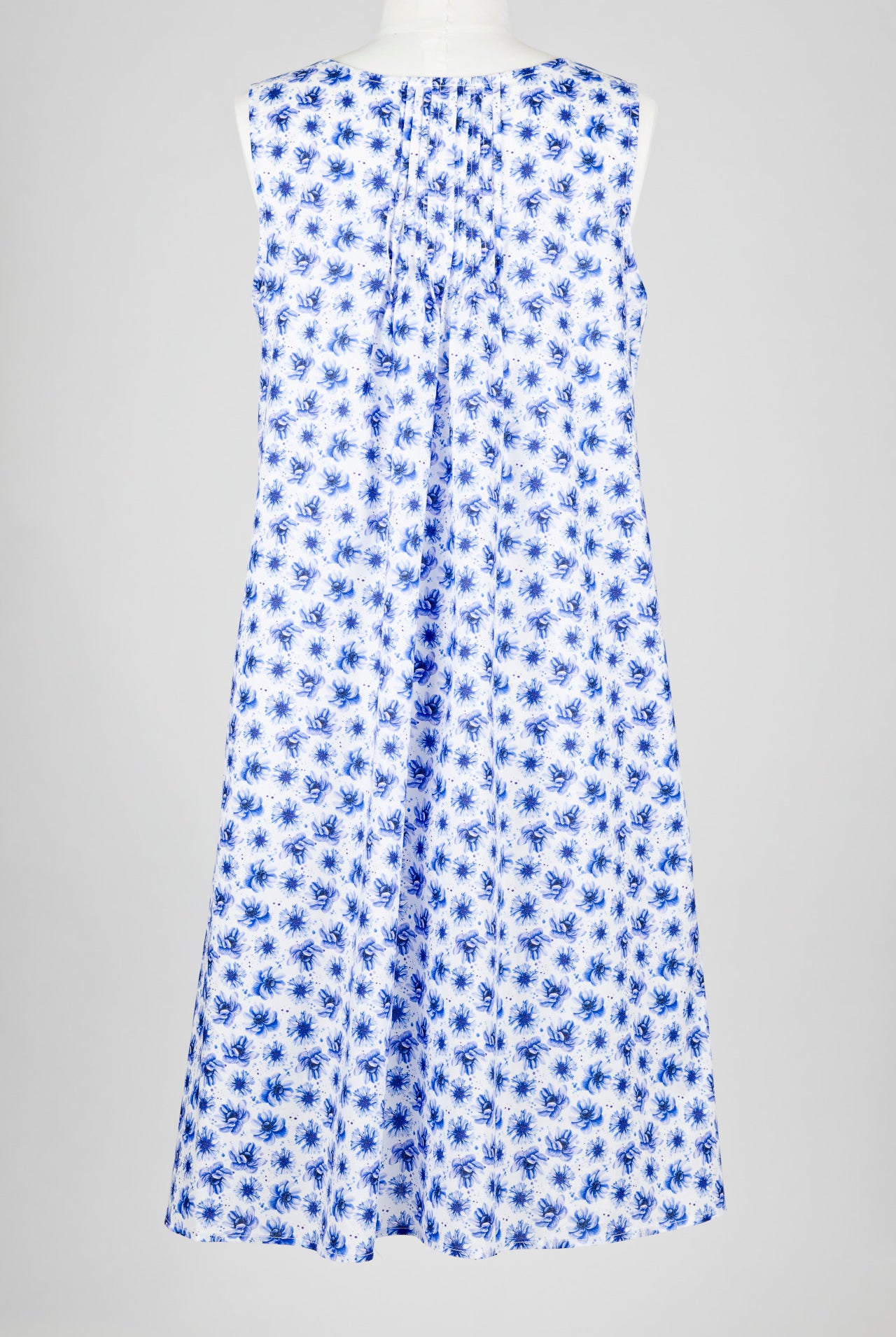 Blue floral cotton nightie dress on a mannequin against a gray background