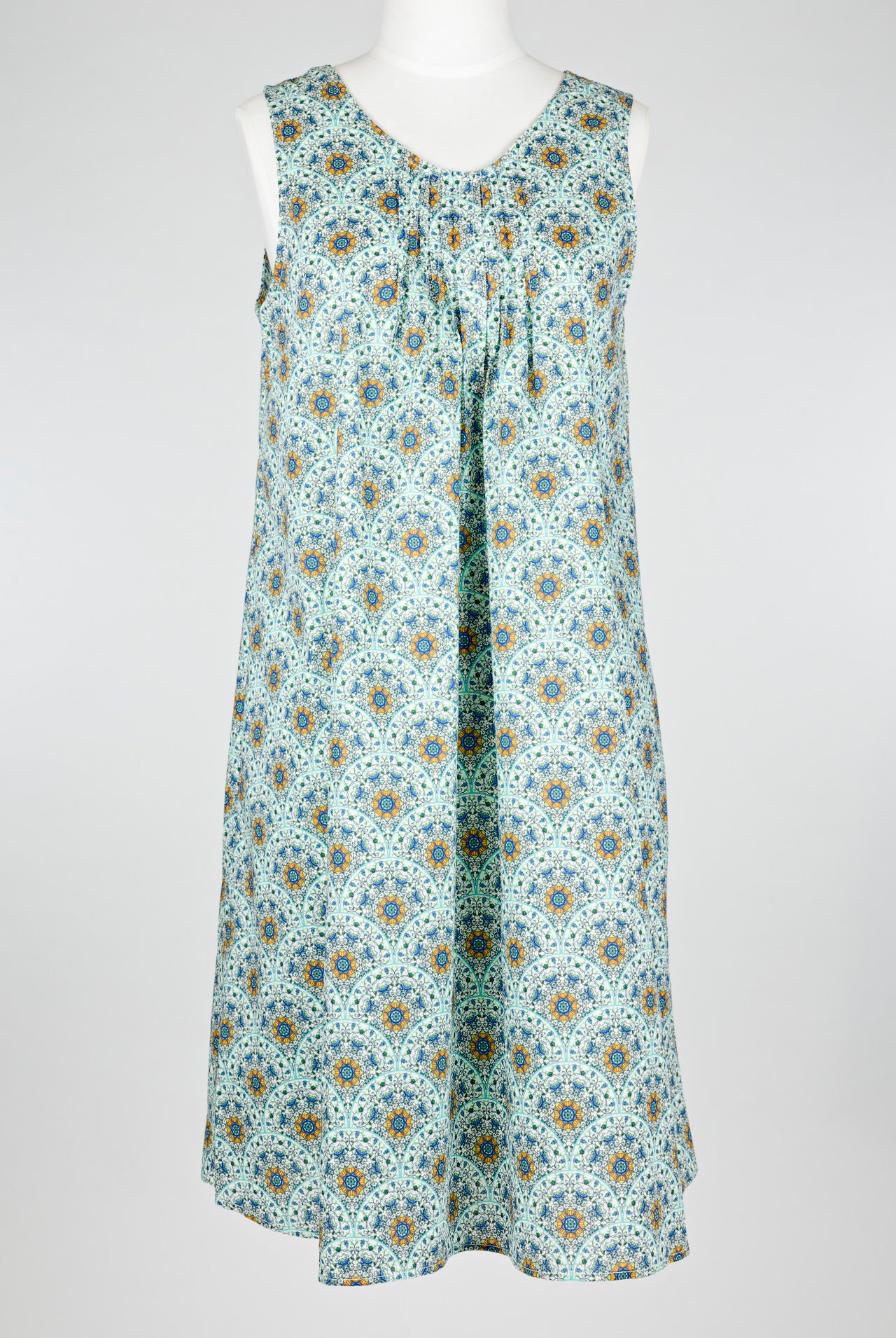 geometric green patterned cotton nightie dress on a mannequin against a white background