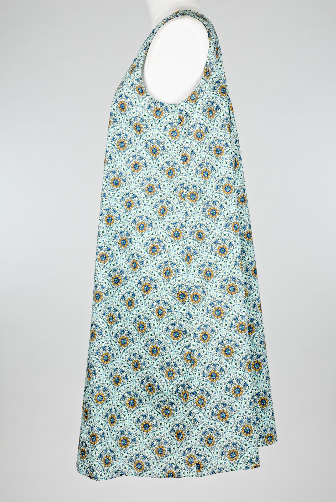 geometric green patterned cotton nightie dress on a mannequin against a white background