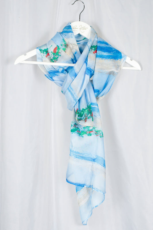 silk chiffon scarf in light blue and green and red print on hanger