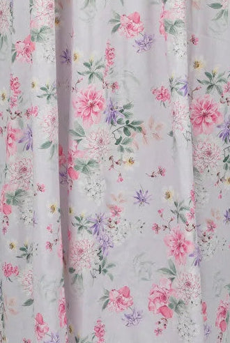 Floral patterned dress on a mannequin against a gray background