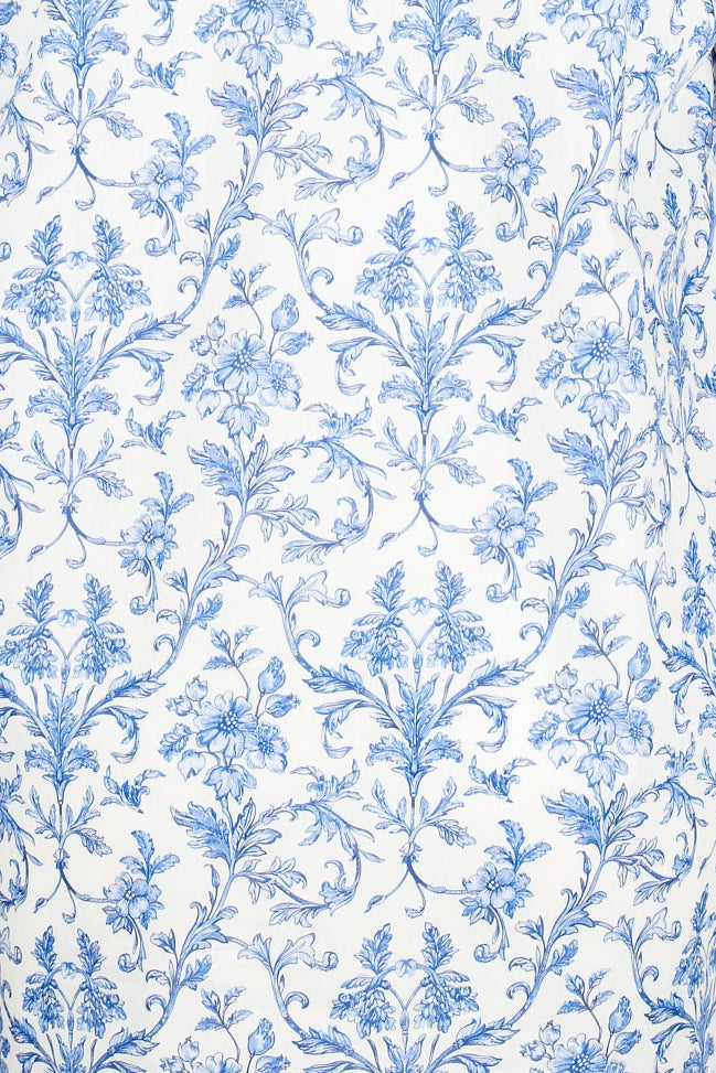 detail of white cotton fabric with blue floral pattern