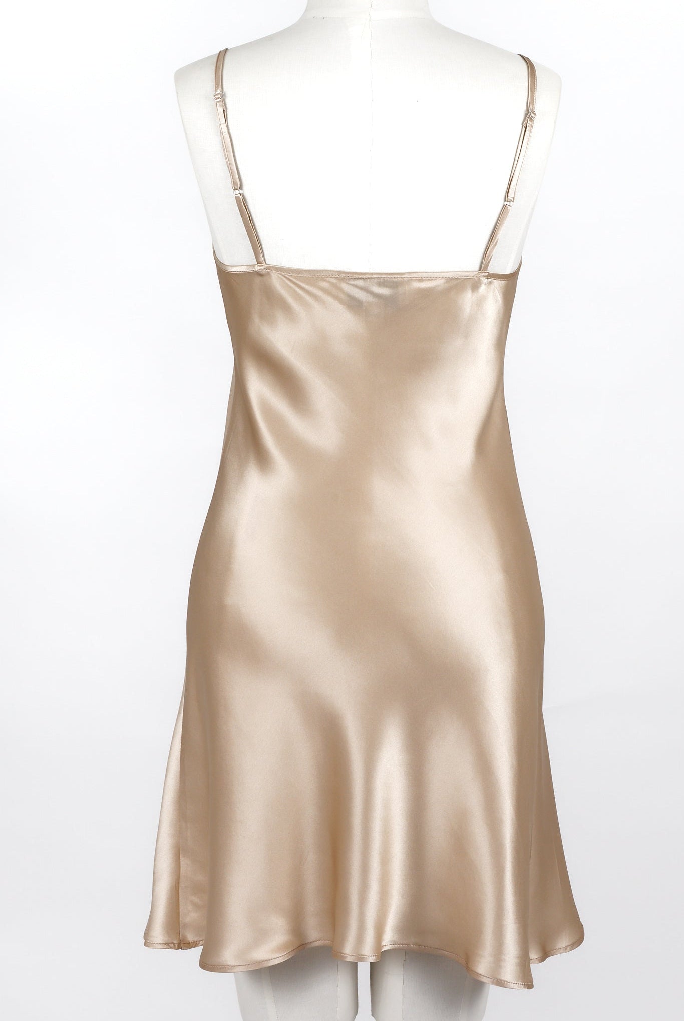 women wearing a nude colour silk slip dress with adjustable straps and v neck