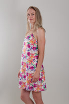 women wearing cotton slip dress nightie with bright floral print in orange and pink flowers