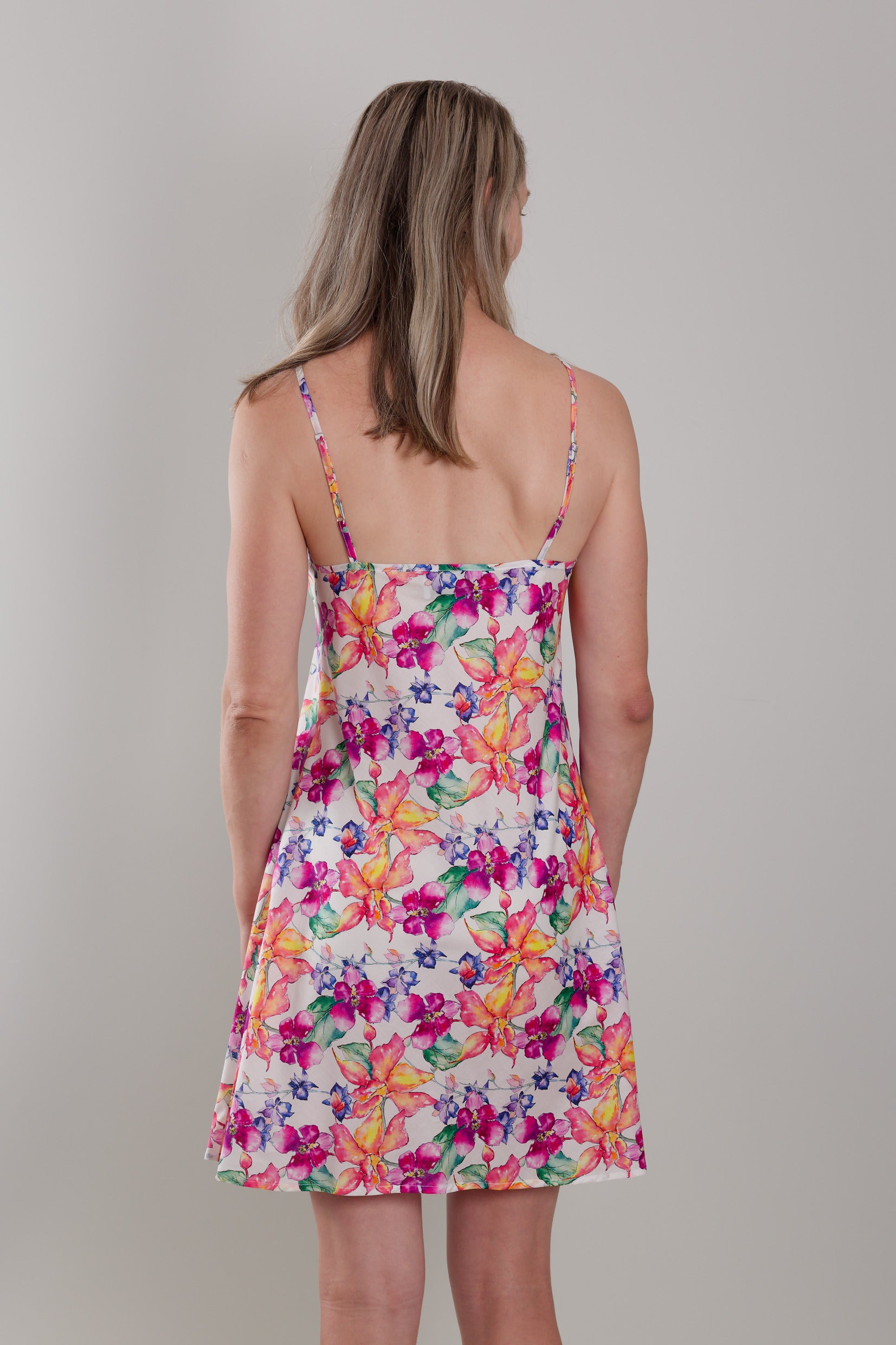 women wearing cotton slip dress nightie with bright floral print in orange and pink flowers