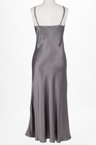 women wearing a dark grey long silk chemise dress with v neck and adjustable straps