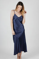 women wearing a long navy silk satin dress 