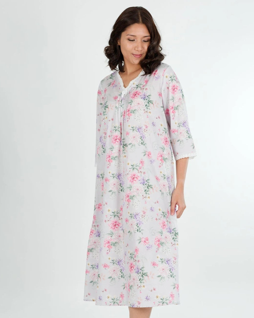 Woman wearing a floral nightgown on a white background
