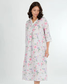 Woman wearing a floral nightgown on a white background
