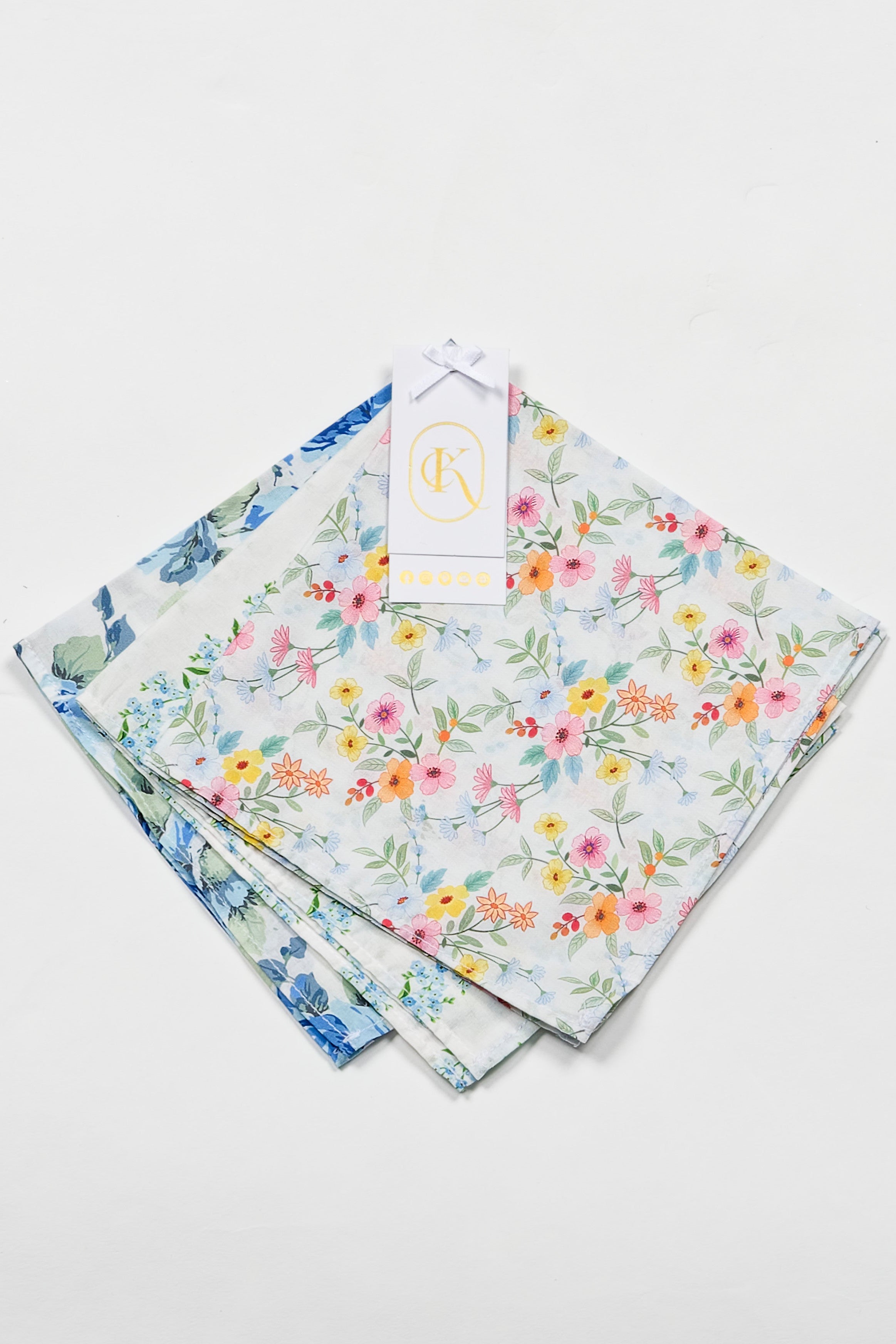Set of floral-patterned fabric womens hankies on a light gray background