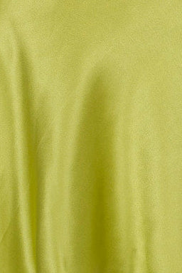 Green satin silk slip dress on a mannequin against a white background