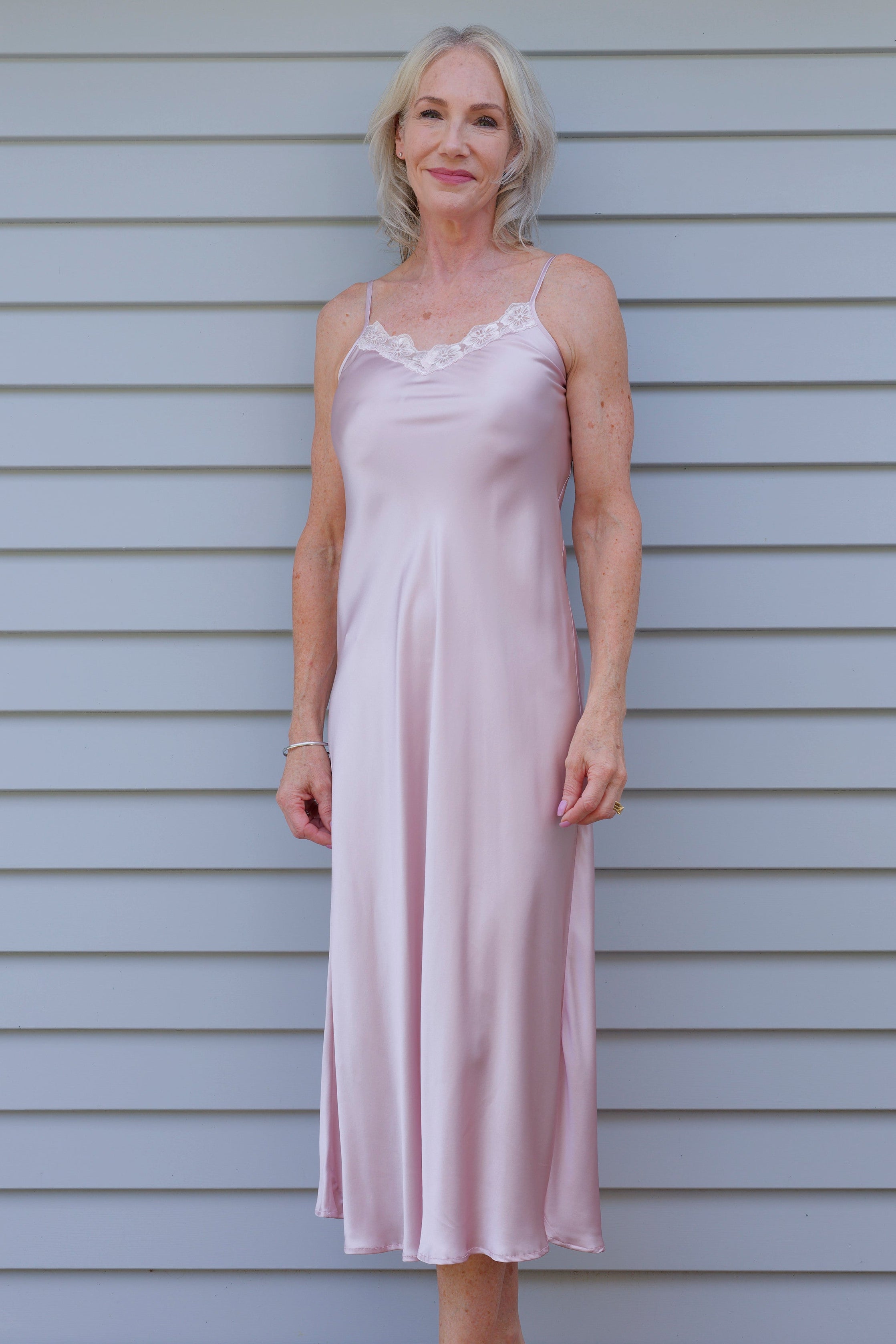 Woman in a pink silk satin nightgown 