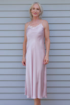 Woman in a pink silk satin nightgown 