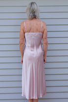 Woman in a pink silk satin nightgown 
