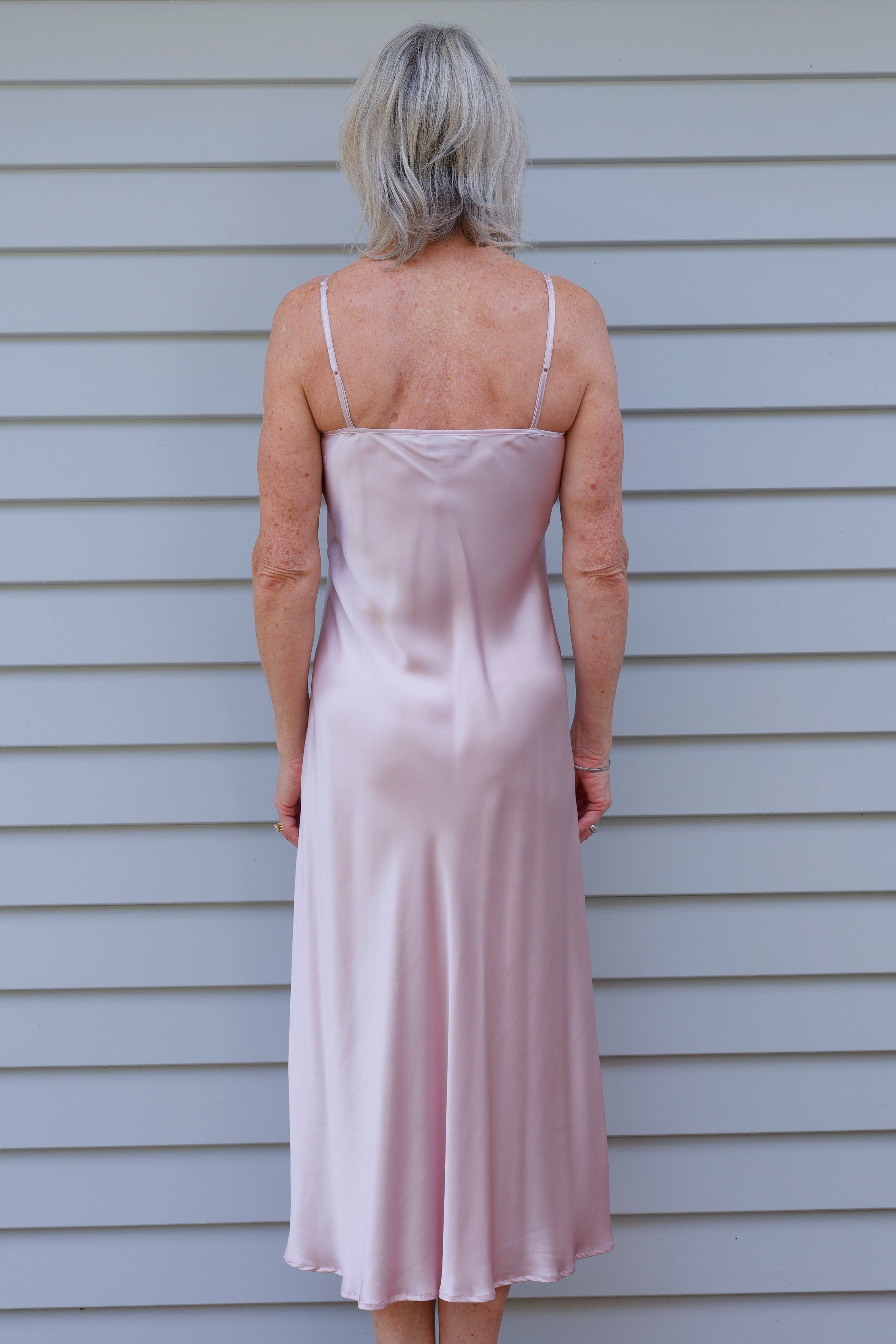 Woman in a pink silk satin nightgown 