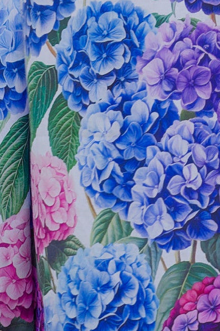 close up of floral cotton nightie with hydrangea flowers on it in blue purple and pink