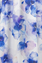 White fabric with a watercolor floral print in shades of blue, purple, and soft pink.