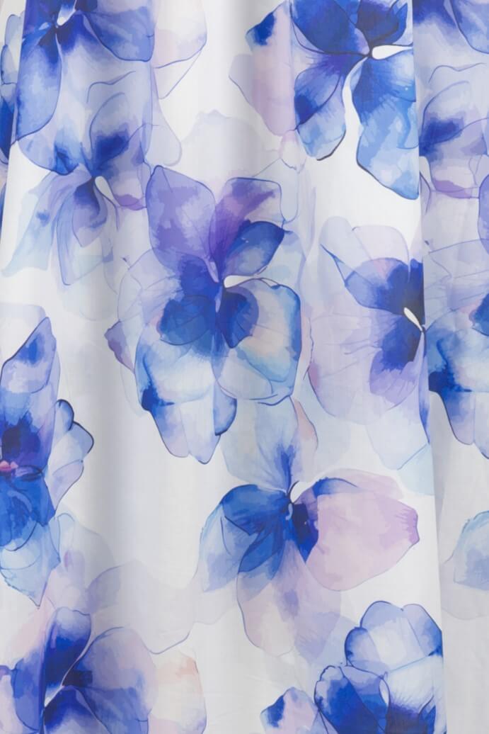 White fabric with a watercolor floral print in shades of blue, purple, and soft pink.