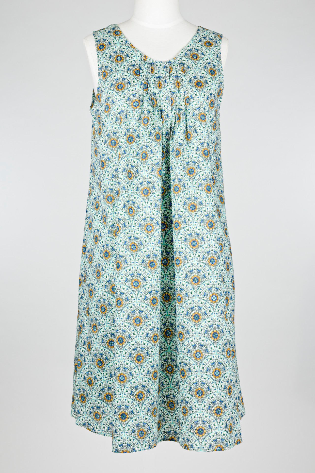 geometric green patterned cotton nightie dress on a mannequin against a white background 