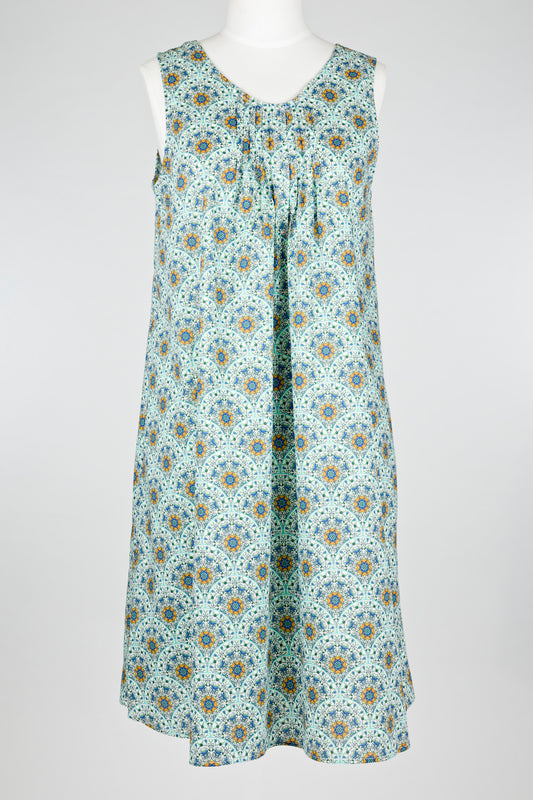 geometric green patterned cotton nightie dress on a mannequin against a white background 