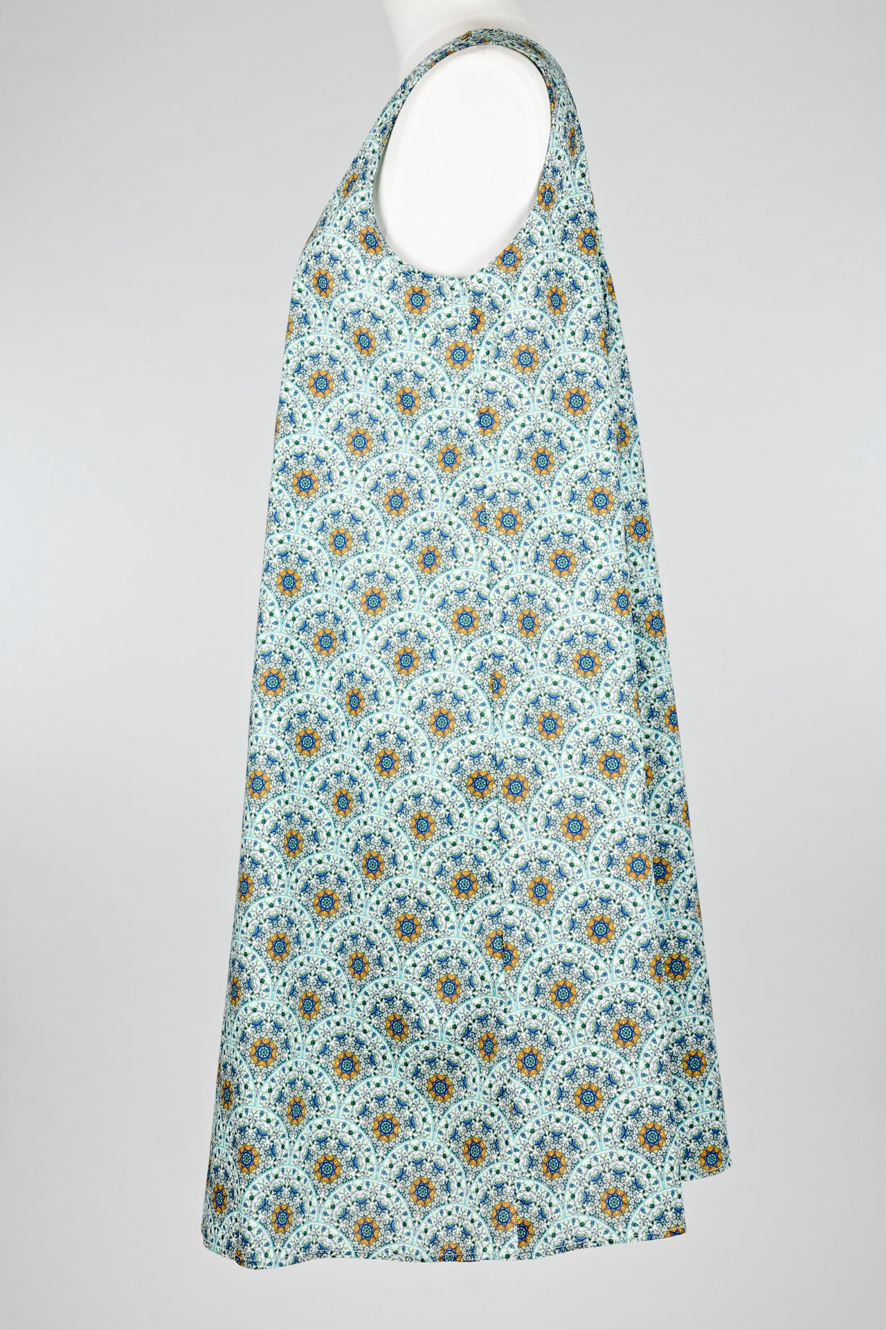geometric green patterned cotton nightie dress on a mannequin against a white background 