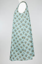 geometric green patterned cotton nightie dress on a mannequin against a white background 