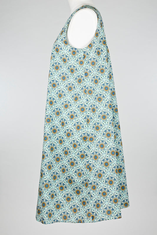geometric green patterned cotton nightie dress on a mannequin against a white background 