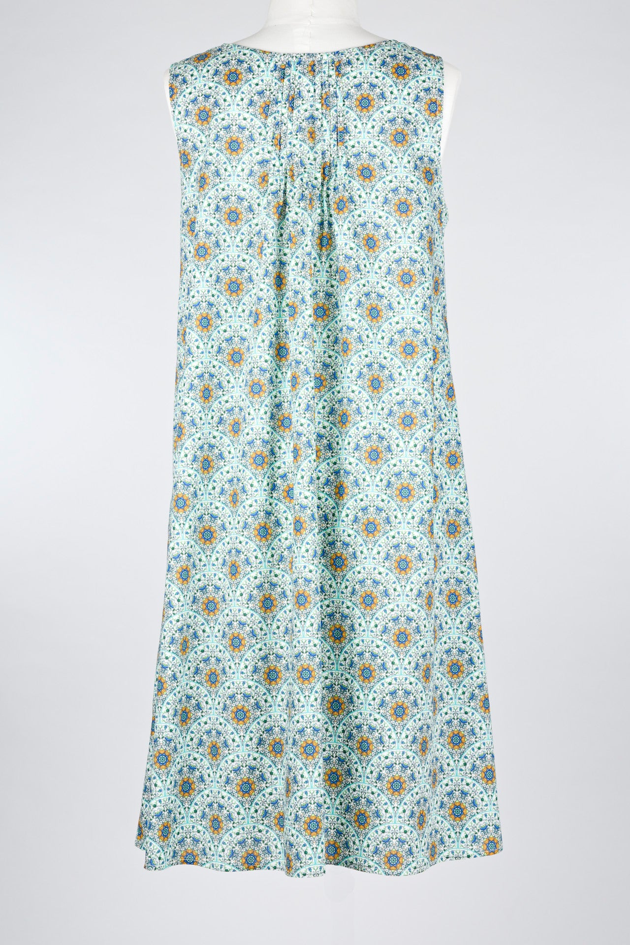 geometric green patterned cotton nightie dress on a mannequin against a white background 