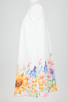 White sleeveless nightie dress with colorful floral patterns on a white background