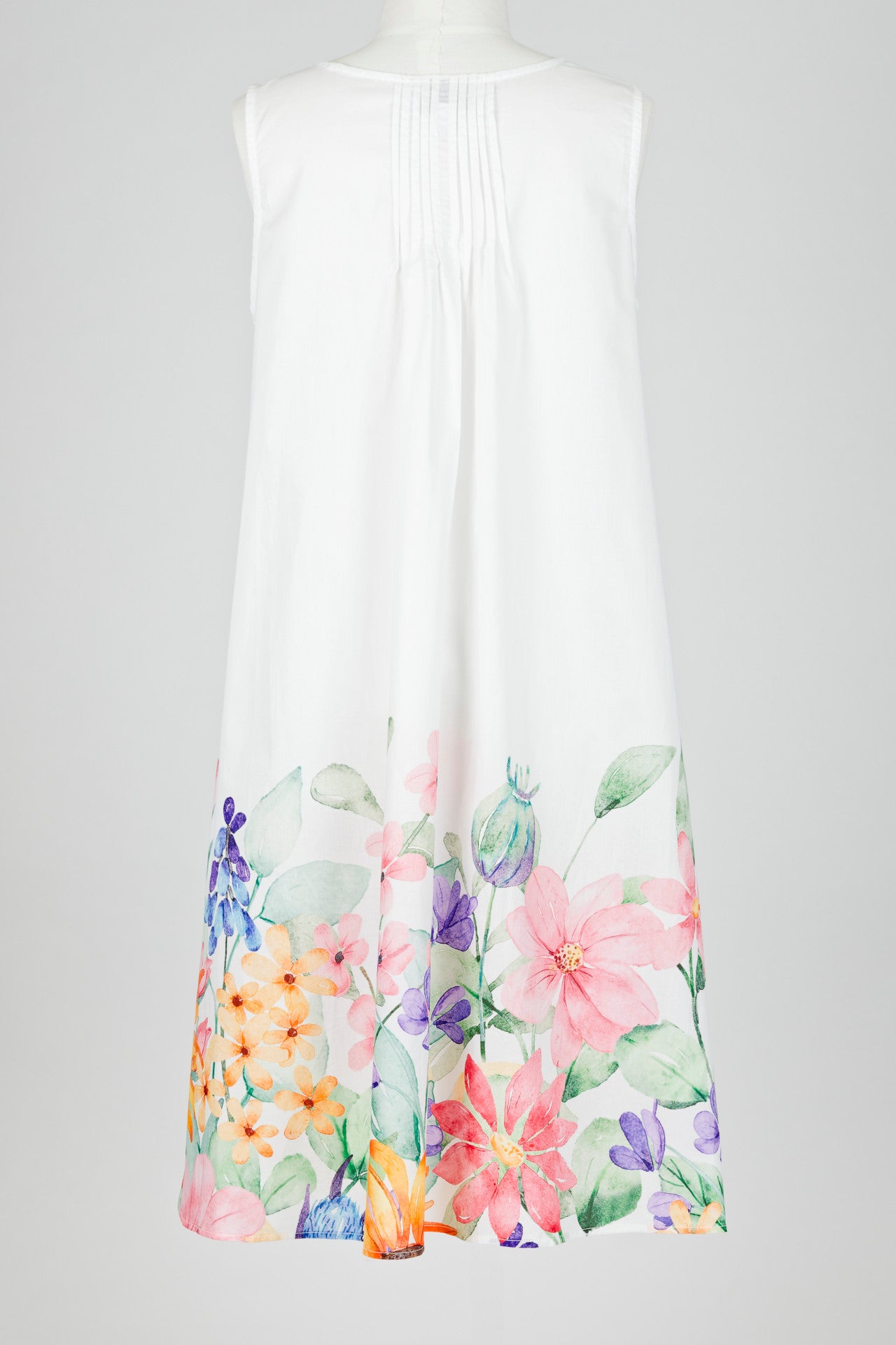 White sleeveless nightie dress with colorful floral patterns on a white background