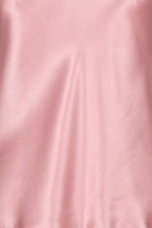 Pink silk satin camisole on a mannequin against a gray background