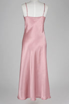 Pink silk slip dress on a mannequin against a gray background