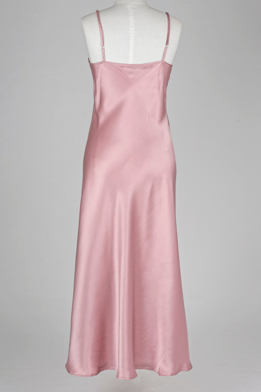 Pink silk slip dress on a mannequin against a gray background
