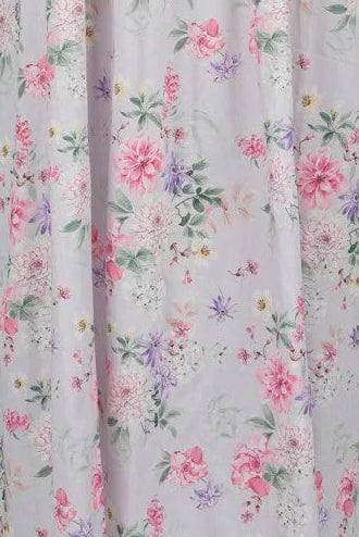 Floral patterned dress on a mannequin against a gray background