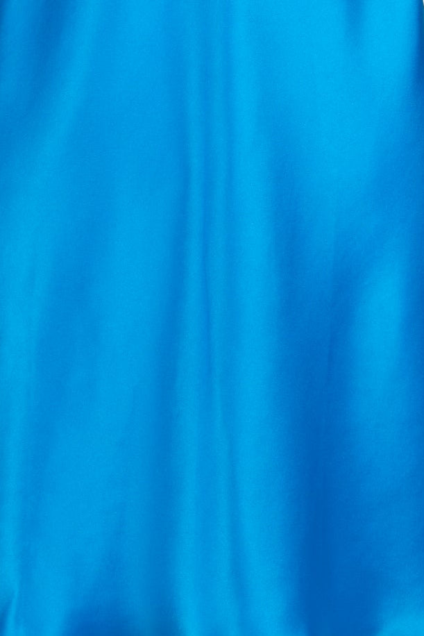 A bright blue satin slip dress with thin straps and a decorative embroidered neckline, displayed on a white mannequin torso against a light gray background.