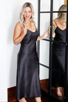 women wearing a long silk chemise slip in black