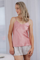 women wearing a light pink rose silk camisole 